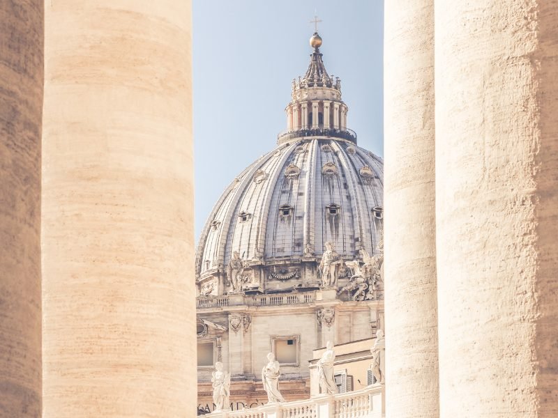 part of the cupola of the basilica as seen through the colonnade pillars