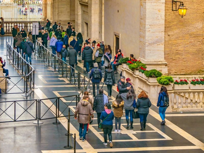 crowd of people lining up at the vatican in high season