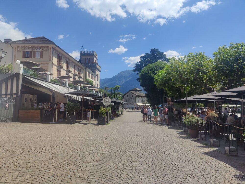 a downtown scene in the lakeside village of ascona with pedestrian street and cafes along the street