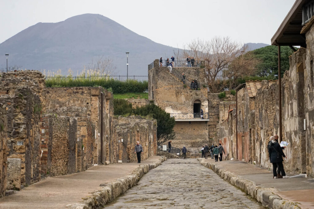 Wandering down the streets of Pompeii and seeing all the pillars and also the volcano in the background looking intimidating