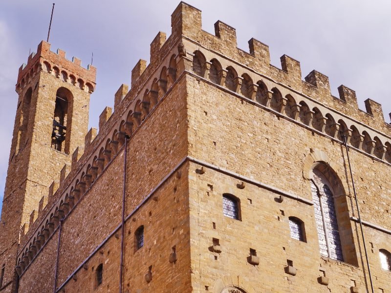 Exterior of the Bargello Museum, one of the first national museums in italy, in a palace-looking building with pinkish-tan stone brickwork