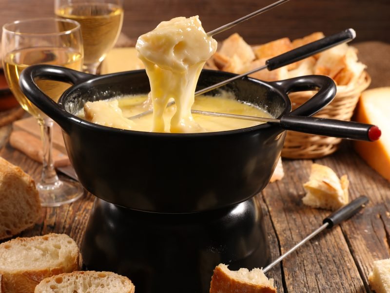 stretchy, pully, gooey fondue cheese with skewers, bread, and white wine