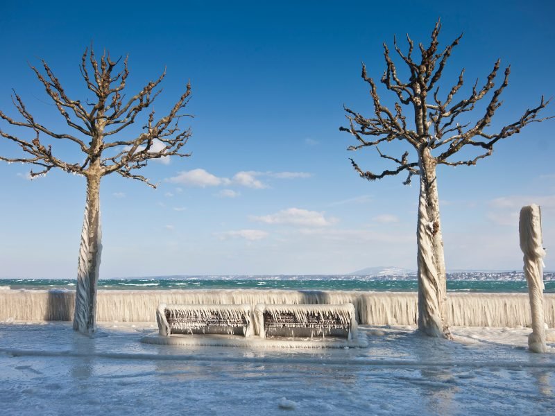 walkway along the shore of lake geneva, covered in ice after a winter storm