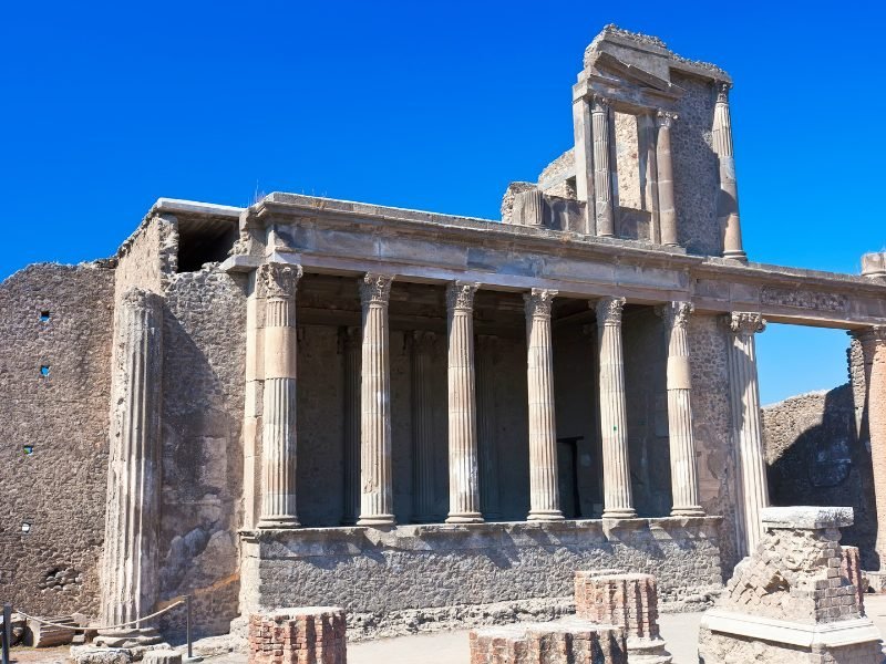 view of the forum columns in pompeii against a sky blue sky