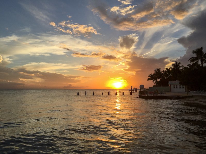 View of the sunset in key west florida with the beautiful water and orange tones of the sunset