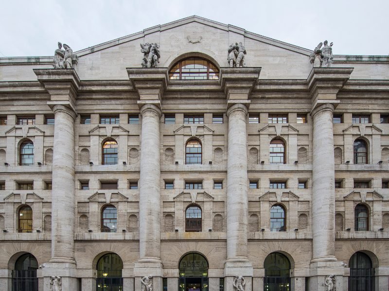 The facade of the Italian Stock Exchange, with four pillars and geometrical shapes on the windows that are replicated throughout