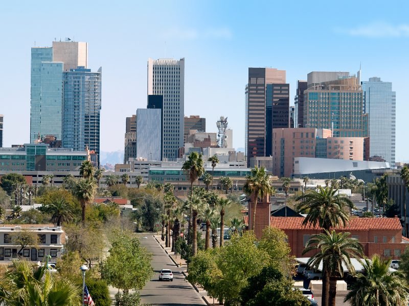 The downtown landscape and cityscape skyscrapers of Phoenix in January with palm trees and beautiful weather.