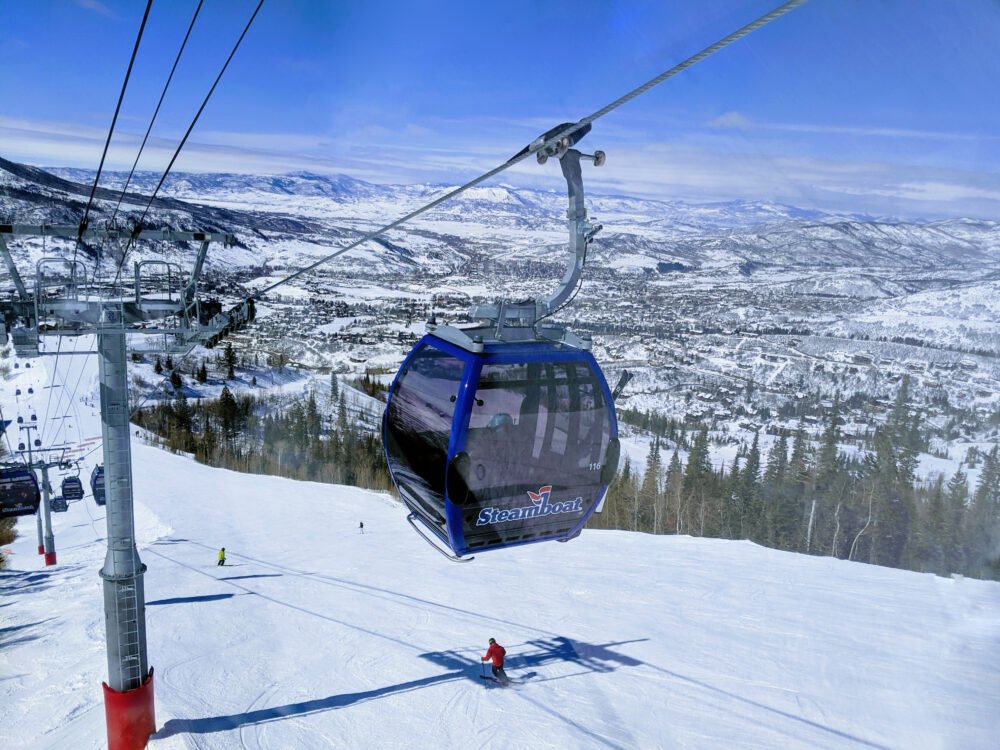 winter gondola in steamboat springs colorado leading up to snow pistes which are already full of snowpack in the december period