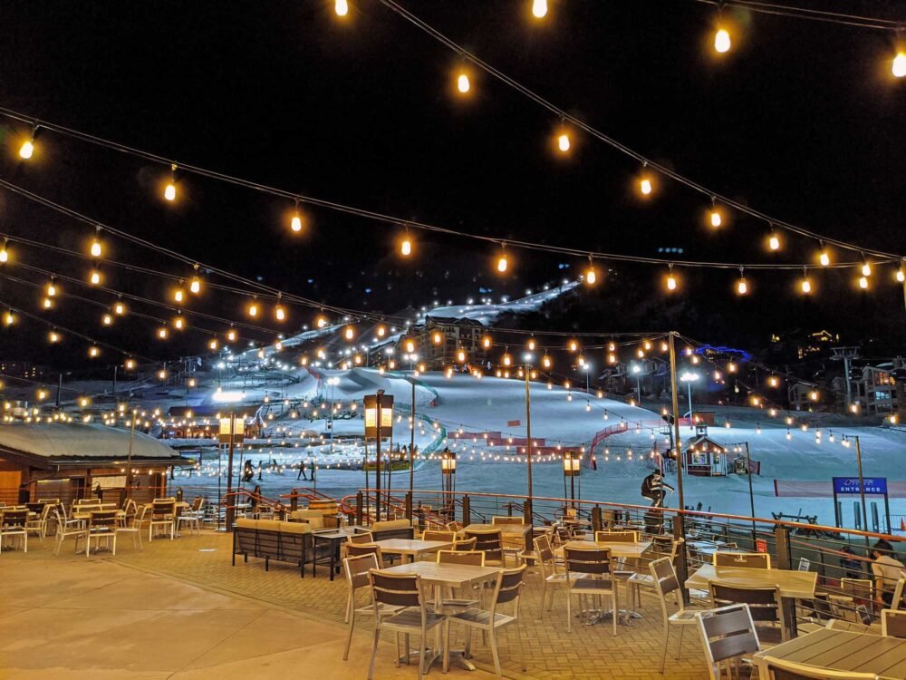 night view of the night skiing options in the steamboat springs resort area with open seating in the restaurant area and lit up christmas lights