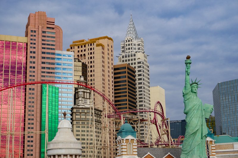 View of the Statue of Liberty and roller coaster and Empire State Building and other buildings of the Las Vegas Strip 