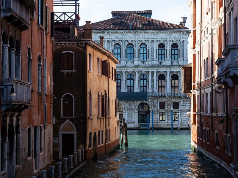 The famous Ca Pesaro Palazzo in Venice, as seen from the front from a view on the canal, with water in front of it. This palace now houses a museum of modern art.