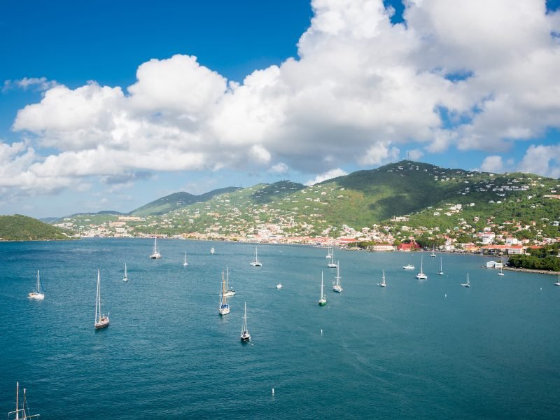 Waters around St. Thomas with sailboats on a perfect day with just a few clouds in the sky but lots of sun so you can see the brilliant color of the water.