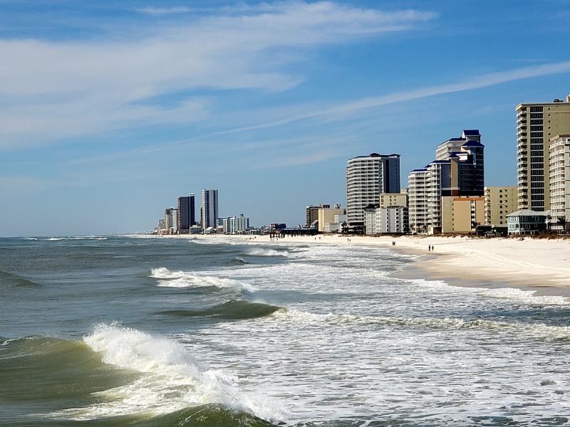 Waves breaking on the beach with skyline in the background in Gulf Shores Alabama a great warm weather destination in the US in January