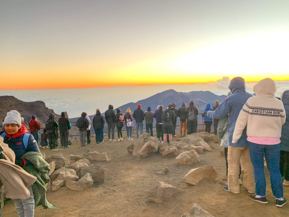 sunrise in haleakala national park with lots of people enjoying the beautiful sights