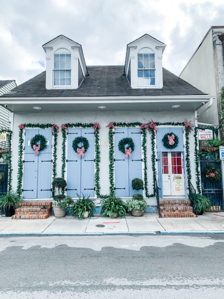 Festive decorations on a blue house in New Orleans in Louisana, a great warm weather destination in December in the USA