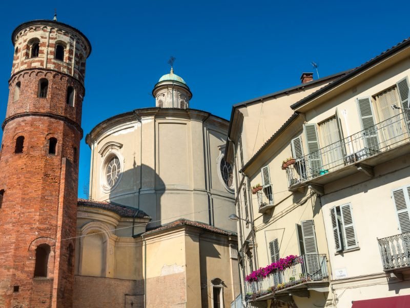red tower of Asti and other religious buildings in a small Piedmont town in italy near Milan