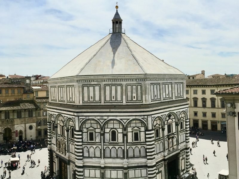 Duomo in Florence, with rounded building and marble artwork with stripes and symmetry