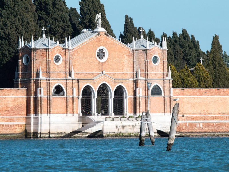 brick building gate leaning up to the cemetery island of san michele in venice