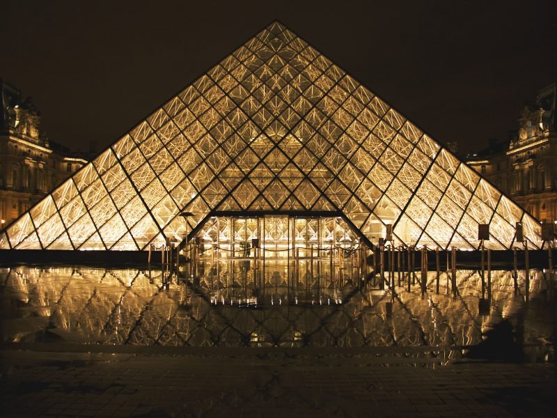 Lit up interior of the glass pyramid in the Louvre as seen at night - you can visit at night on Friday and the first Saturday of each month