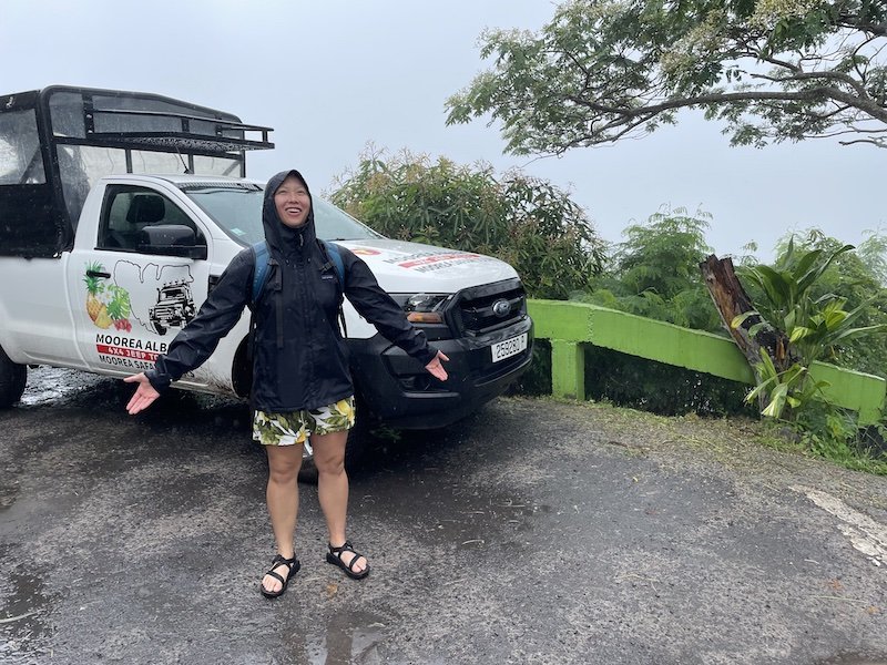 A rainy day in Tahiti wearing a rain jacket and hat