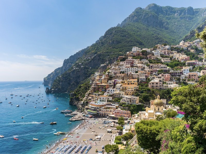 the beaches of positano with the town in the background