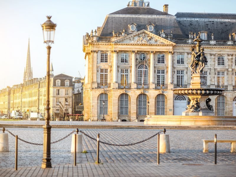 view of the bourse palace in bordeaux with morning light falling on the building in a beautiful light