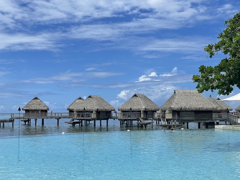 Infinity pool in front of overwater bungalows at Manava resort in Moorea on a sunny day