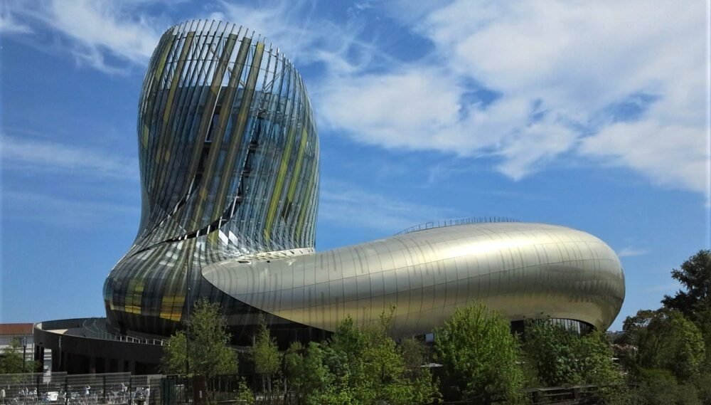 the cite du vin museum in the daylight with serpentine metallic architecture in a fluid movement shape