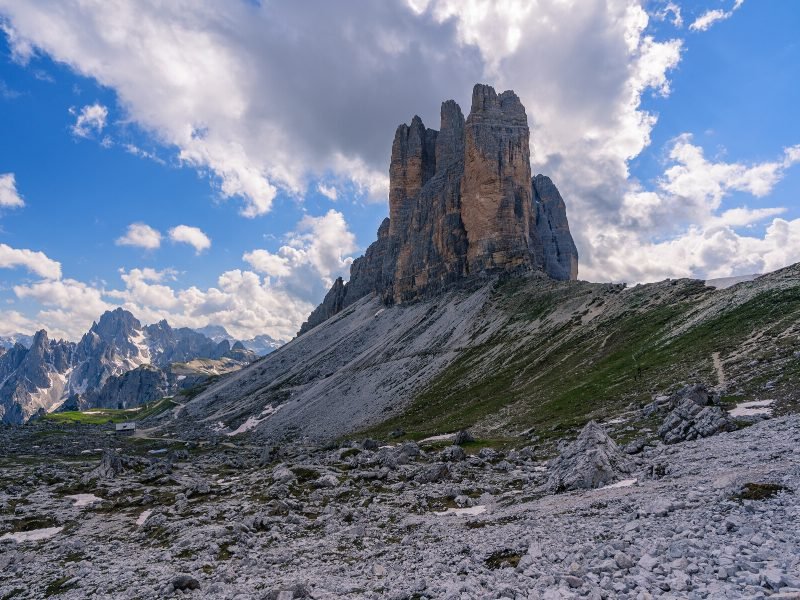 Mountains in the Dolomites range on a cloudy day with rock-strewn trail