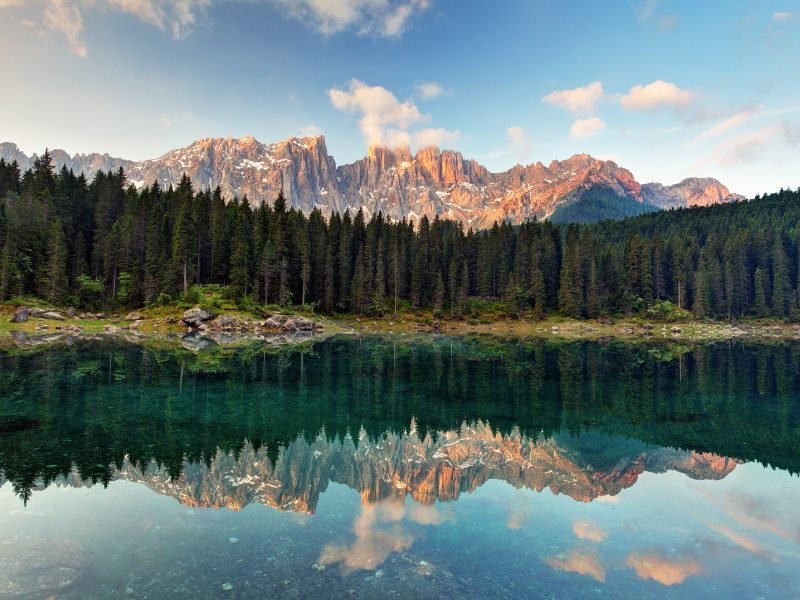 view of a lake in the dolomites around sunset with beautiful lights