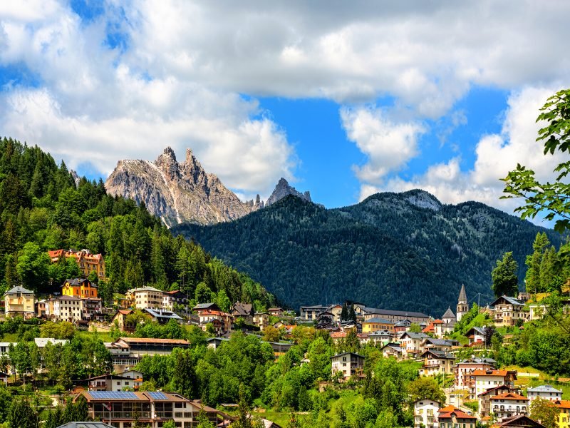 The small town of Pieve di Cadore with colorful houses at the foot of the mountains