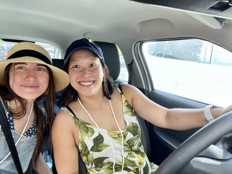 Allison and her partner in a rental car in tahiti