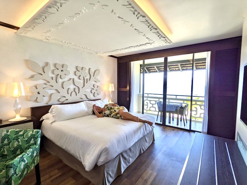 Allison's partner laying on the bed in the king room with Moorea view at the Intercontinental Tahiti