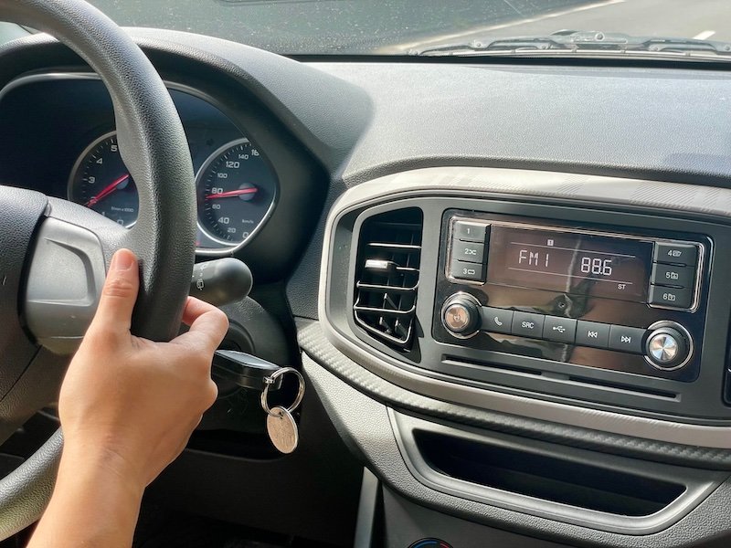 Driving in Tahiti with hands on steering wheel and radio set to 88.1