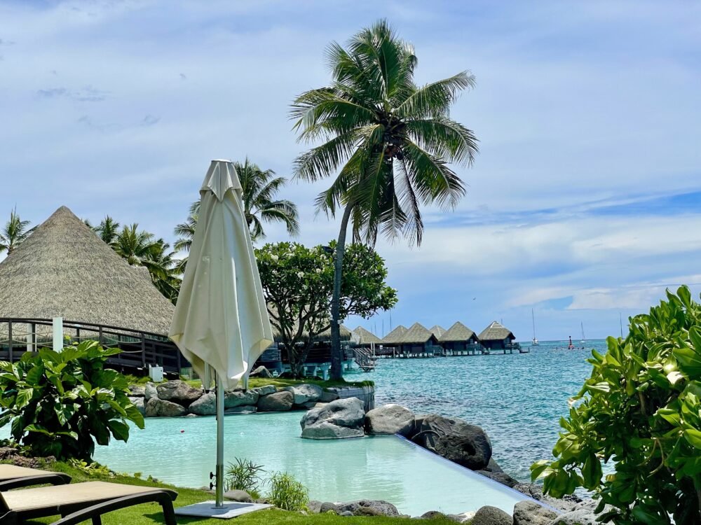 View of pool and resort and bungalows off in the distance in Tahiti