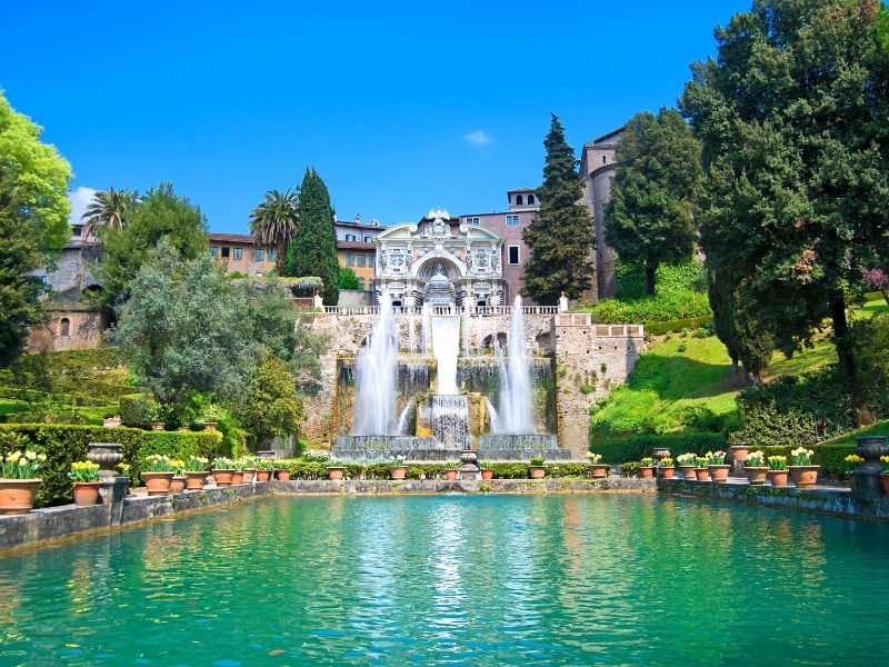 The famous Villa d'Este in Tivoli with a large reflecting pool, fountains, and exquisite marble detailing in the backyard of this famous old palace