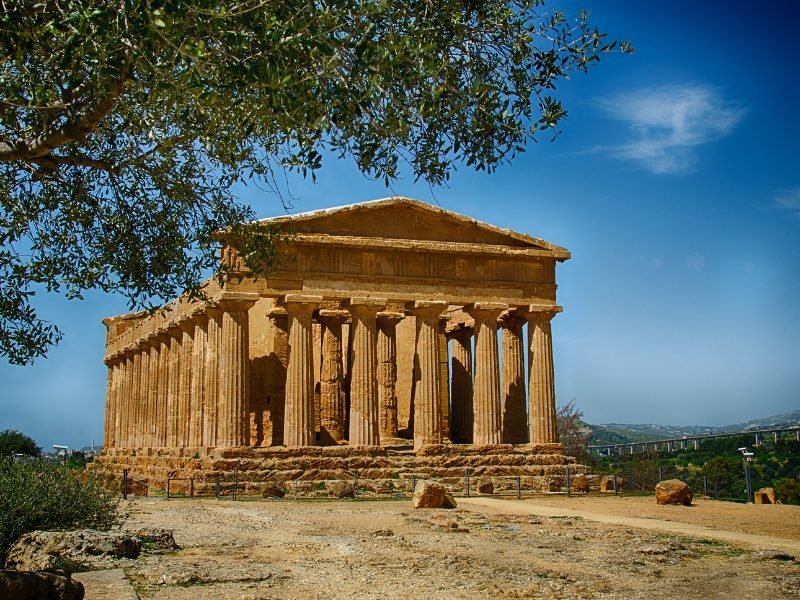 One of the temples in Agrigento part of the Valley of the Temples on a clear day with a little bit of clouds in the sky