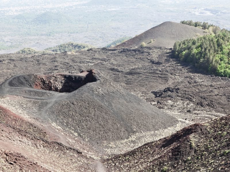 Craters in the ash as you hike Mt. Etna, an active volcano in Sicily Italy