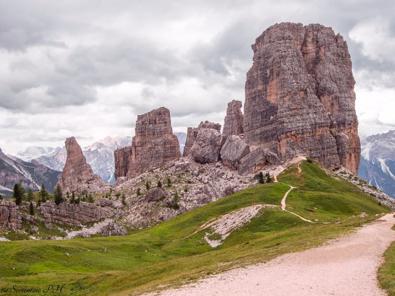 The "Cinque Torri" or five towers formation in the Dolomites, and a hiking trail, with large tower-like rocks and a trail