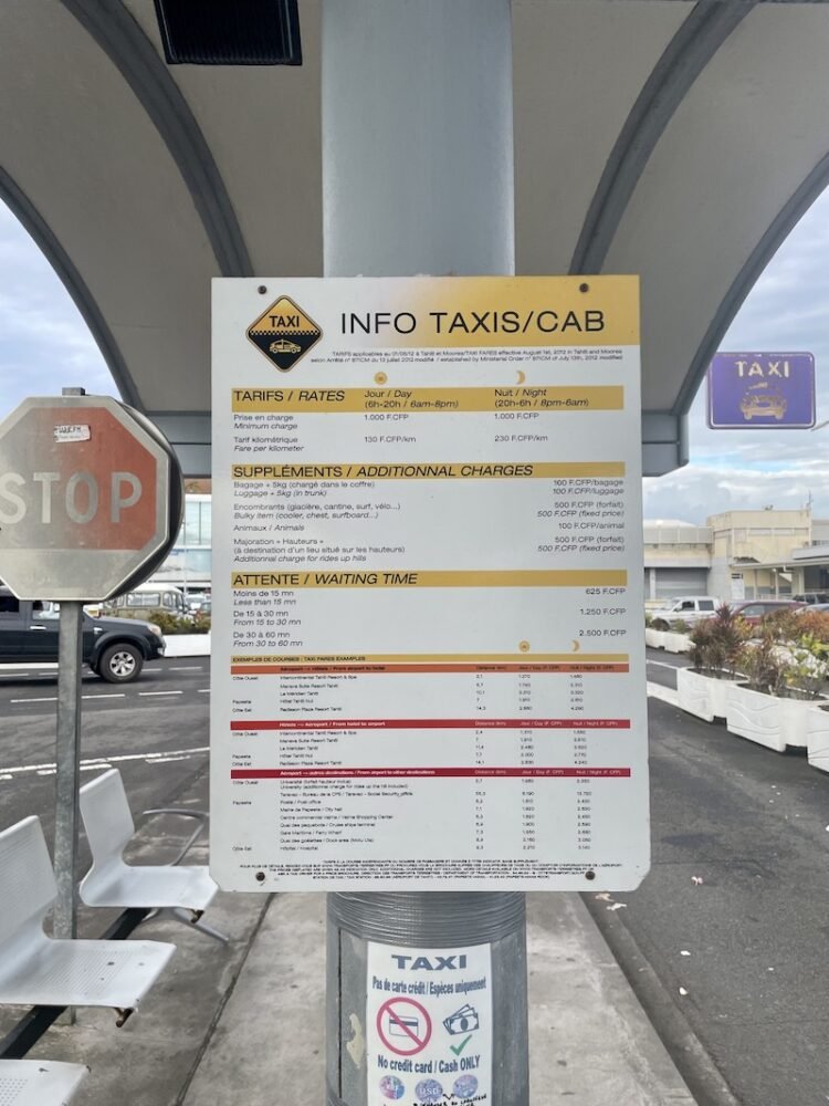 Sign listing the taxi costs in Tahiti and Moorea at the airport