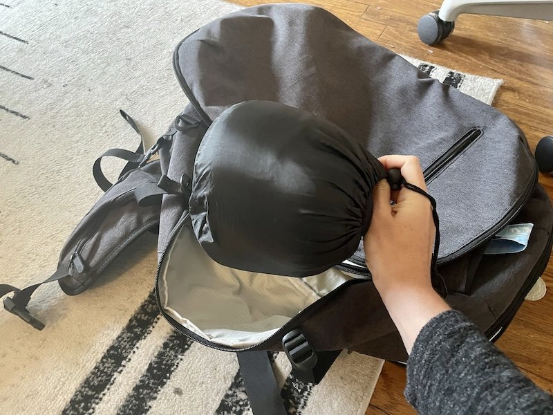 My scrunched up travel pillow next to backpack for scale