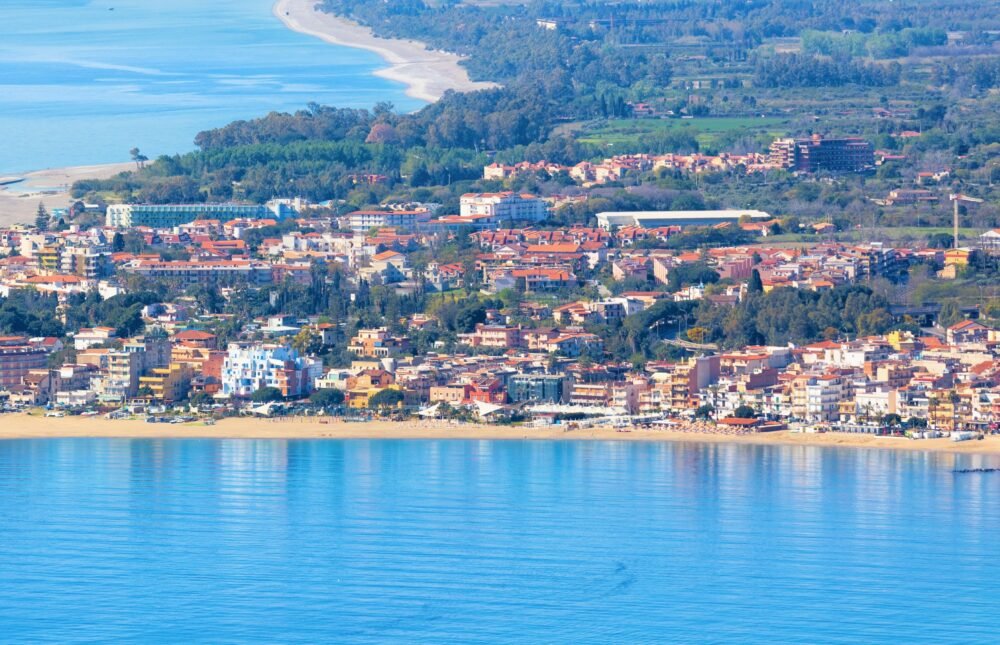 The long sandy beach of Spiaggia Schiso in a town adjacent to Taormina, a nearby Taormina beach in Giardini Naxos, a small Sicilian town