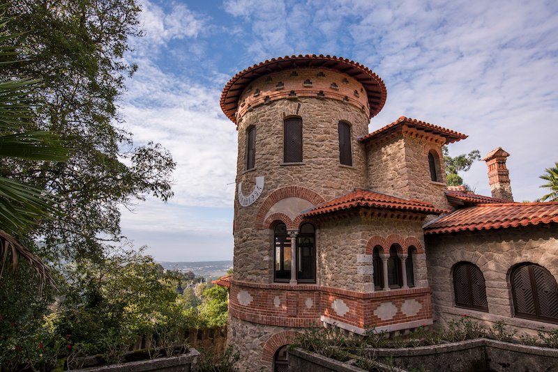 Views of Villa Sassetti in Sintra, with view over the city from a hilltop, circular tower with arches and mosaic and stonework