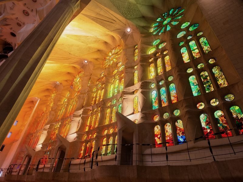 The Sagrada Familia interior with stained glass creating beautiful light patterns scattered all over the building
