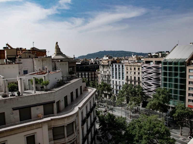 The architecture of the tree-lined Passeig de Gracia with interesting buildings and wide avenue