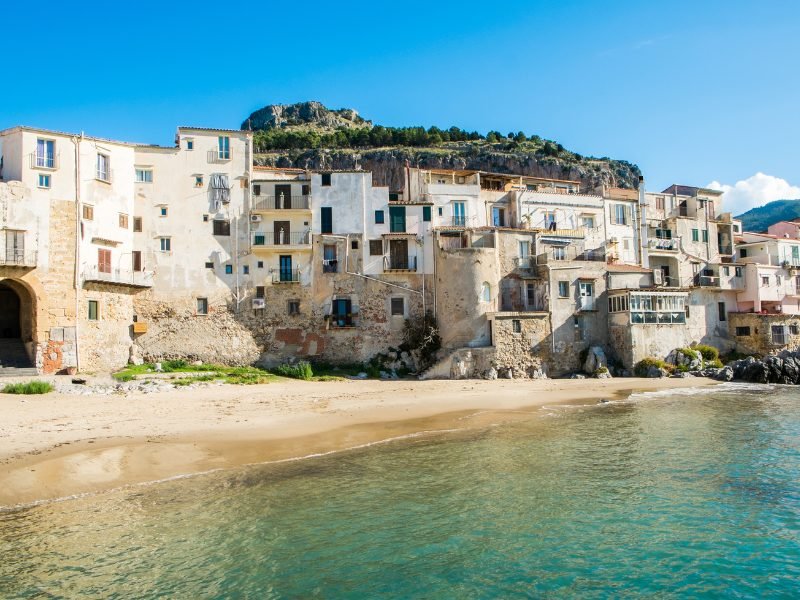 A charming white-washed beach town in Sicily with view of sea and houses