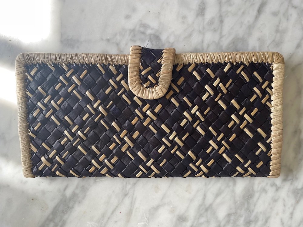 Hand woven wallet with dark and light fronds woven together to make a pretty and unique pattern