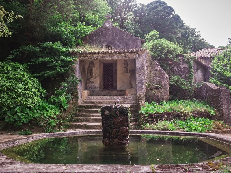The quiet, calm convent of the capuchos with a fountain and an old chapel made of stone