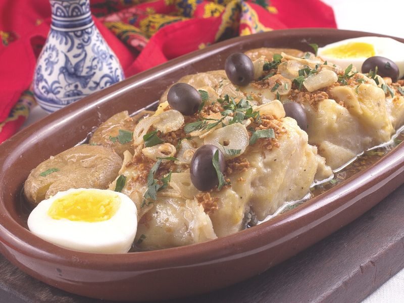 Bacalhau (codfish) with olives, garlic, parsley and hard boiled egg, a portuguese classic dish.