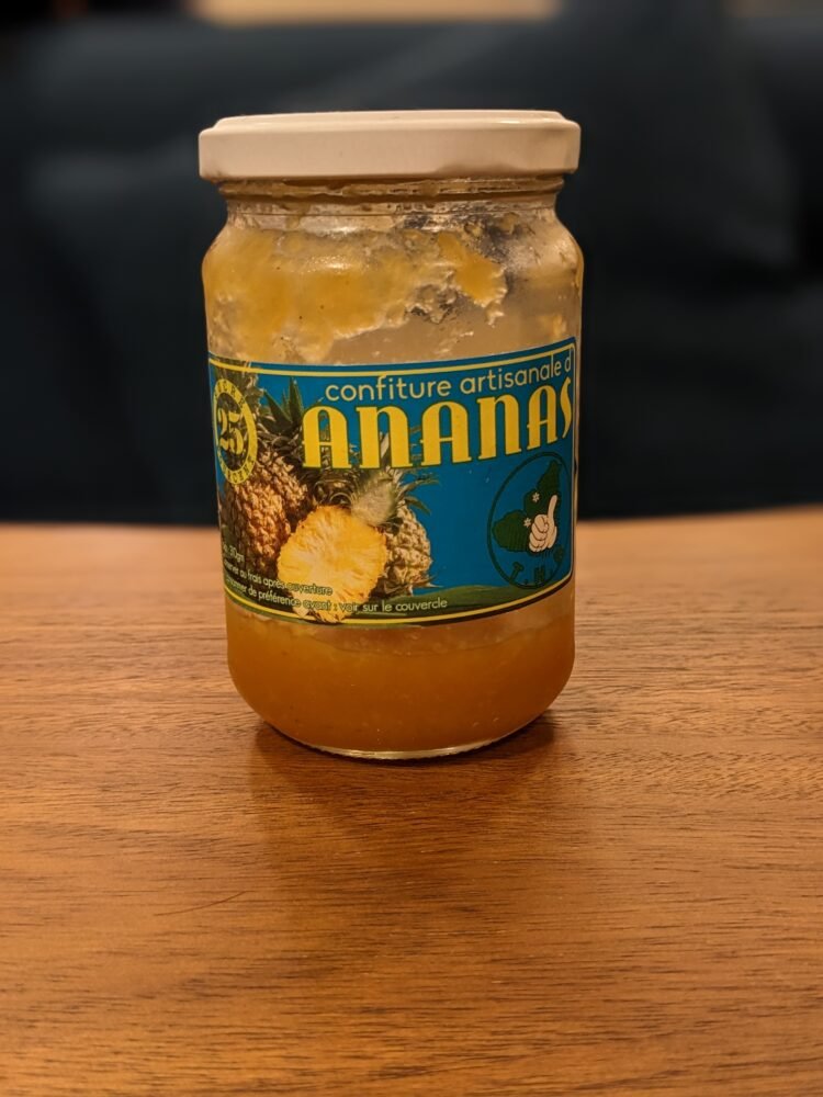 jar of pineapple jam from moorea with french words that mean "artisanal jam of pineapple"